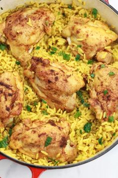 chicken and rice in a skillet with parsley on the side, ready to be eaten