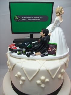 a wedding cake with a bride and groom on top