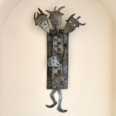 a metal sculpture is hanging on the wall