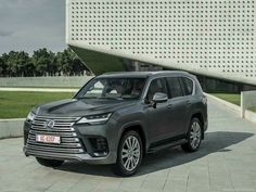 a grey suv parked in front of a building