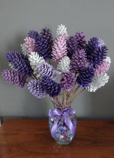 a vase filled with purple and white flowers