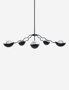 a black and white chandelier with five lights hanging from it's sides