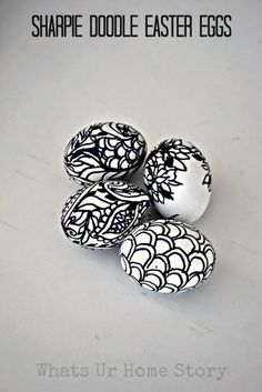 three black and white eggs sitting next to each other on top of a table with the words, sharpie doodle easter eggs