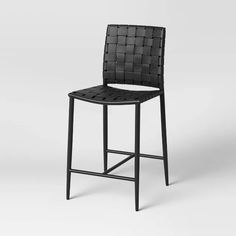 an image of a bar stool that is made out of black leather and has a woven seat