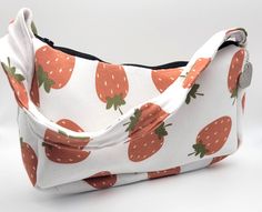 This adorable strawberry patterned bag will complete any outfit. Its soft cotton spandex fabric makes it easy to hold for long periods time, which makes it great for going out. This purse will easily hold your phone and a small wallet while you're running errands or going to a fair.  SIZE ▹9¼"L x 1½"W x 4¼"H ▹Shoulder strap is 17" long ▹Shoulder strap is about 7¼" from the top of the bag  COLORS ▹White cotton and spandex fabric with a strawberry pattern ▹Strawberries are red with green  ▹Cream c Custom Purses, Strawberry Pattern, Long Periods, Pocket Book, Fabric Pattern, Green Cream, Color Lines, Small Wallet, Spandex Fabric