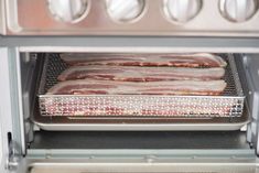 bacon is cooking in the oven and being cooked