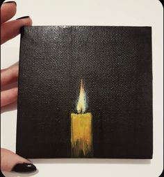 a painting of a lit candle on a black canvas with yellow and white paint in the middle