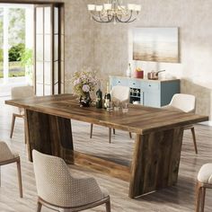 a dining room table with chairs around it and a chandelier hanging from the ceiling