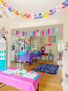 a birthday party with colorful streamers hanging from the ceiling and decorations on the wall