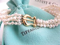 Overview:Every woman needs a strand of pearls ... but here's a piece that's more special than just any strand of pearls ... because it's made by Tiffany! :) Offered for sale is a wonderful Tiffany & Co. Picasso 18K Gold Buckle Multi Strand Pearl strand bracelet. Whether you are just starting your collection or are thinking of adding another piece, this one is perfect for you. This pearl bracelet is a gorgeous classic that will never go out of style. The piece is composed of 4 pearl strands with Luxury Pearl Bracelet With Charm, Luxury Pearl Chain Bracelet For Anniversary, Luxury Pearl Charm Bracelets For Gifts, Luxury Pearl Charm Bracelet For Gift, Luxury Pearl Charm Bracelet As Gift, Luxury Pearl Drop Bracelet For Gift, Luxury Pearl Charm Bracelets As Gift, Luxury Akoya Pearl Bracelet With Pearl Chain, Luxury Akoya Pearl Bracelets For Wedding