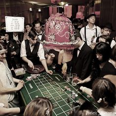 a group of people standing around a roule game