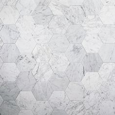 a white marble wall with hexagonal tiles