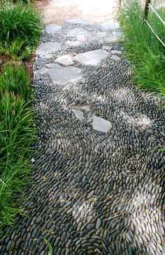 a walkway made out of stones and grass