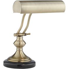 an antique brass desk lamp on a black base