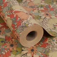 an image of a flowered wallpaper with a roll of paper on top of it