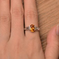 It is a natural citrine ring. The main stone is 7mm*9mm oval cut, weight about 1.77 carats. The basic metal is sterling silver and plated with rhodium. To change the metal to a solid gold (white/rose) or platinum is also available, please ask for a quotation if you want. You can also go to my shop Home for more elegant rings: https://www.etsy.com/shop/godjewelry?ref=hdr_shop_menu More rings: https://www.etsy.com/shop/godjewelry?ref=l2-shop-header-avatar Customization is always welcome and please Oval Citrine Solitaire Jewelry, Oval Solitaire Citrine Jewelry, Oval Amber Topaz Ring, Amber Birthstone Ring, Orange Oval Topaz Rings, Oval Citrine Birthstone Ring For Anniversary, Oval Citrine Birthstone Ring With Center Stone, Oval Citrine Promise Ring, Orange Oval Topaz Promise Ring