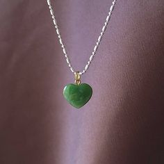 Beautiful heart jade necklace, Gorgeous translucent green. The pendant is made from nephrite jade mined from British Columbia, Canada. We currently only have the gold plated jump ring in stock. The pendant comes with a stainless steel jumpring. Option to buy sterling silver chain necklaces. Jade brings harmony and contentment to the wearer. In Asian cultures, Jade is revered as the good luck stone which can bring happiness, wealth, and friendship. 15mm x 15mm x 4.85mm 4.6 grams Dainty Green Charm Necklace With Round Pendant, Green Pendant Necklace For Valentine's Day, Dainty Green Heart Pendant Necklace, Green Heart Cut Necklace For Gift, Green Double Heart Jewelry With Heart Charm, Green Dainty Jewelry For Valentine's Day, Green Double Heart Charm Jewelry, Green Heart Necklace With Charm For Valentine's Day, Green Heart Charm Necklace For Valentine's Day