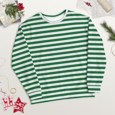 Treat yourself or a loved one to the ultimate cozy wardrobe staple! This green striped shirt is made from a soft and durable material that feels great to wear. Plus, the inside's brushed fleece gives an extra comfy feel.  Whether you're running errands or having a relaxing night in, this crewneck sweatshirt is the perfect gift for anyone.  Get your hands on it now and experience true comfort and style! ✨ SPECIFICATIONS ✨ * 95% recycled polyester, 5% spandex * Fabric weight (may vary by 5 9.08 oz Striped Long Sleeve Sweatshirt For Winter, White Long Sleeve Sweater With Horizontal Stripes, Striped Winter Sweatshirt With Ribbed Cuffs, Striped Sweatshirt With Ribbed Cuffs For Winter, Oversized Striped Long Sleeve Sweatshirt, White Cotton Sweater With Horizontal Stripes, Green Long Sleeve Tops With Contrast Stripes, Striped Oversized Cotton Sweatshirt, Oversized Striped Cotton Sweatshirt