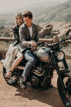 a man and woman are sitting on a motorcycle