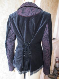 Fabulous Joe Browns velvet jacket with 3 silver buttons to close and a black lace trim at the hem.  The collar is maroon and black tweed which is also on the cuffs and pockets  and inside of sleeve.  The back waist has a black ribbon to lace up.  The lining inside is black with cream flowers.  Excellent condition. Bust,  pit to pit;  20" Inside sleeve;  18" Length;  27" Made by JOE BROWNS