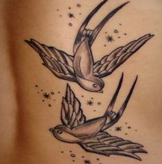 two birds flying in the sky with stars on their back side tattoo designs for women