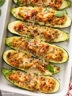 zucchini stuffed with meat and cheese in a baking dish