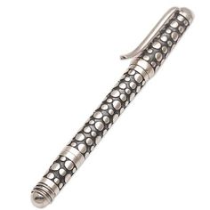 a silver pen with dots on it