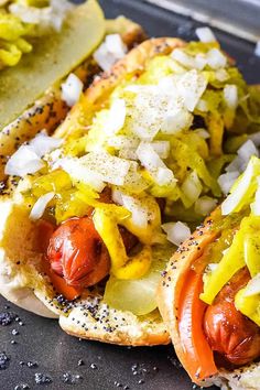 two hot dogs on buns with onions and mustard