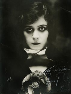 black and white photograph of a woman with dark makeup