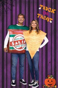 a man and woman dressed up as trick or treat with chips in front of them