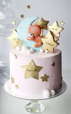 a cake decorated with stars and a baby on the moon is for someone's first birthday