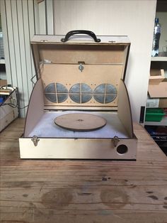 an open suitcase sitting on top of a wooden table