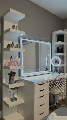 a room with a desk, mirror and shelves on it's sides is shown