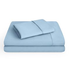 two sheets and one pillow are folded on top of each other in light blue color