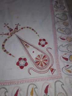 an embroidered table cloth with designs on it