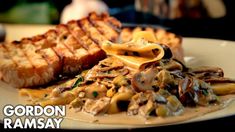 a plate with pasta, mushrooms and bread on it