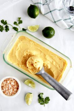 an image of a bowl of ice cream with limes and other ingredients around it