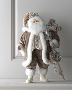 there is a statue of santa claus holding a key in his hand and standing next to the door