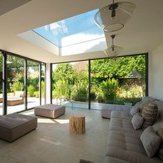 a living room filled with furniture and lots of windows