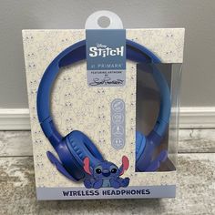 the box is open to show the headphones in it's packaging, which includes an image of stitch