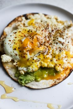 an omelet with eggs and broccoli on a white plate