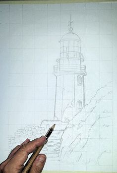 a hand holding a pencil drawing a lighthouse