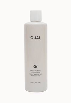 a bottle of ouaiu pet shampoo on a white background with the word ouaiu written in black