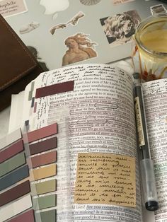 an open book sitting on top of a table filled with papers and paint swatches