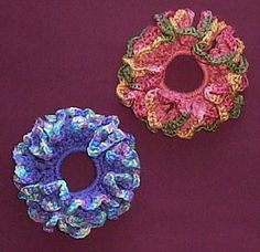 two crocheted scrunffles sitting next to each other on a purple surface