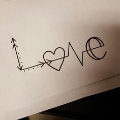 a piece of paper with the word love drawn on it and an arrow pointing up