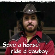 a man wearing a cowboy hat with the words save a horse, ride a cowboy