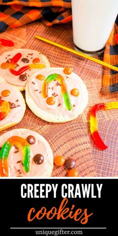 some cookies with candy on them and the words creepy crawly cookies