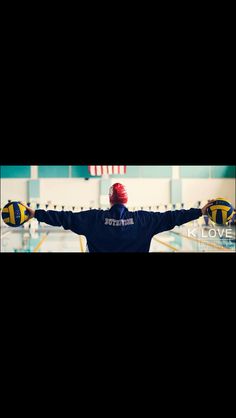 a man standing in front of a swimming pool holding his arms out to the side