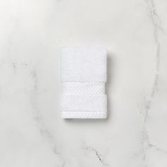 a white towel sitting on top of a marble counter